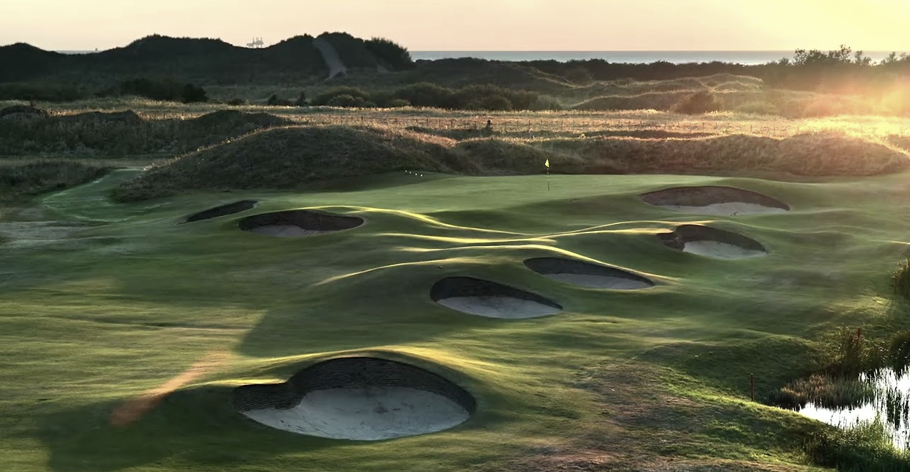 Aerial view of Royal Birkdale's bunker-lined fairways and green at golden hour