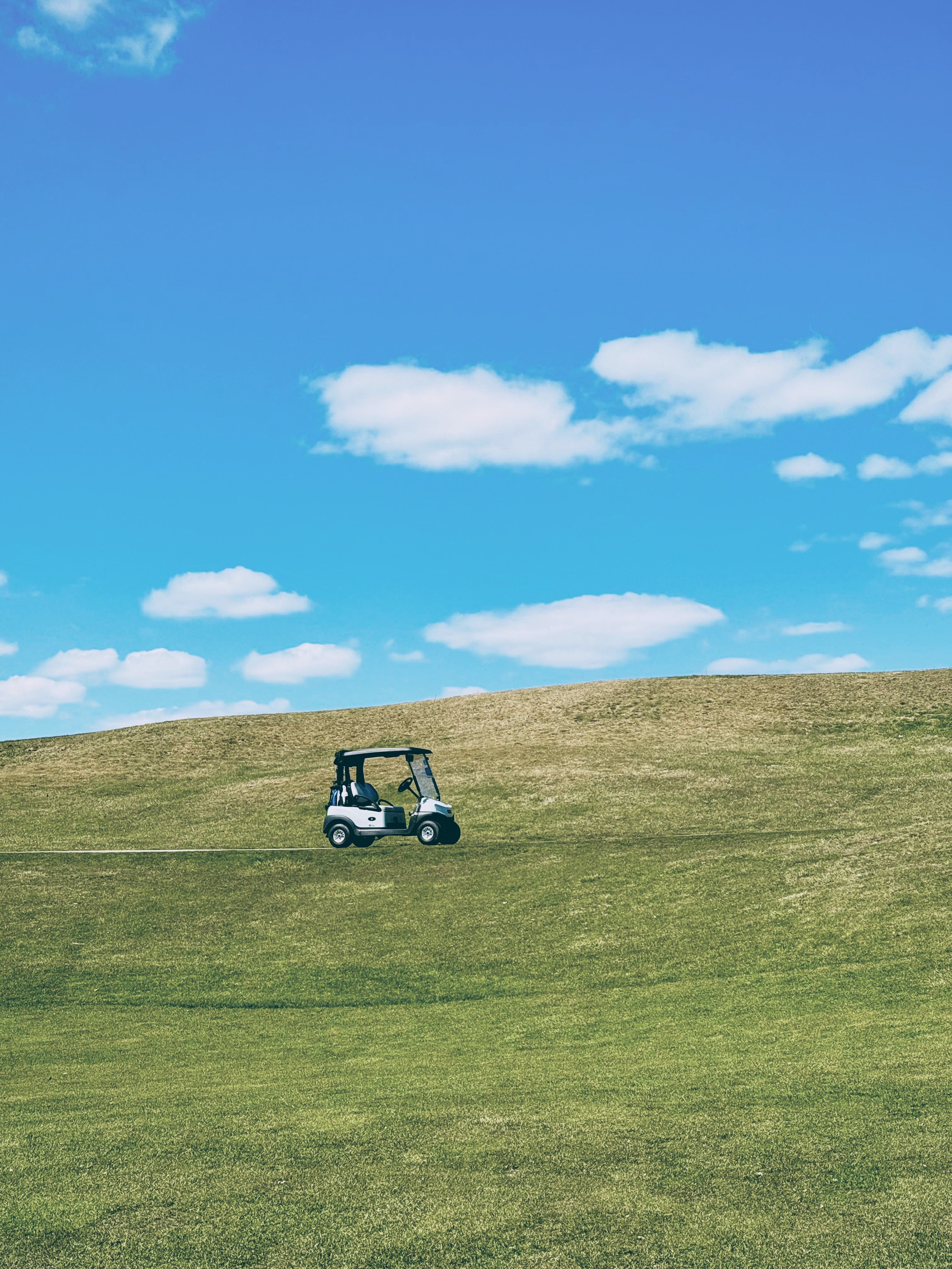 Golf cart on fairway at golden hour